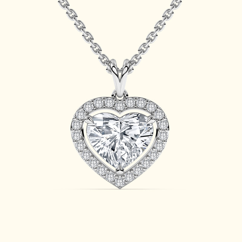 Heart-shaped diamond pendant on a silver chain, surrounded by smaller diamonds.