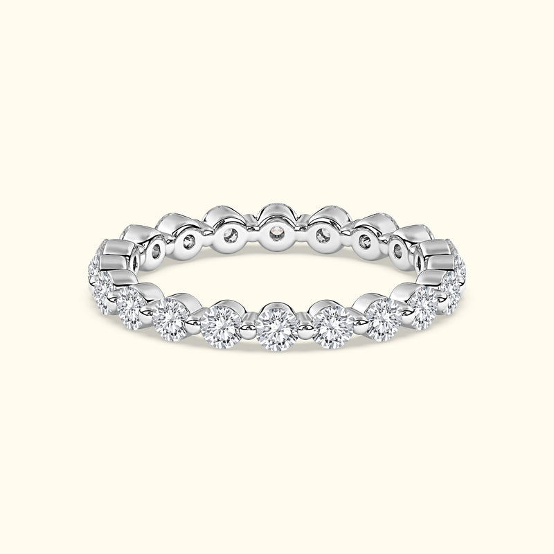 Elegant silver ring adorned with sparkling diamonds around the band.