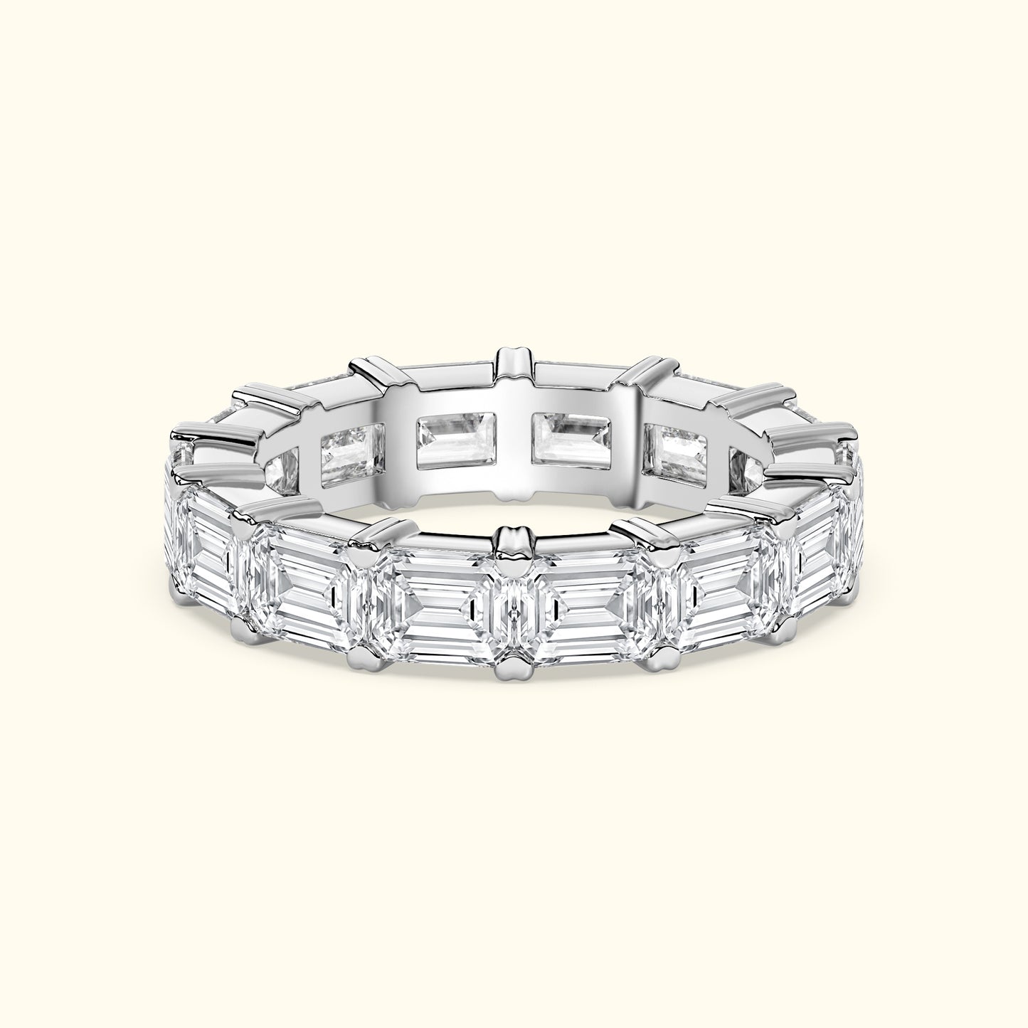 Elegant diamond band featuring alternating emerald-cut diamonds in a sleek setting.