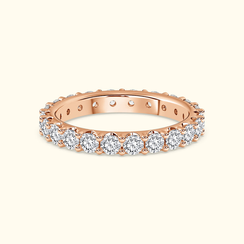 Rose gold ring set with sparkling diamonds around the band.