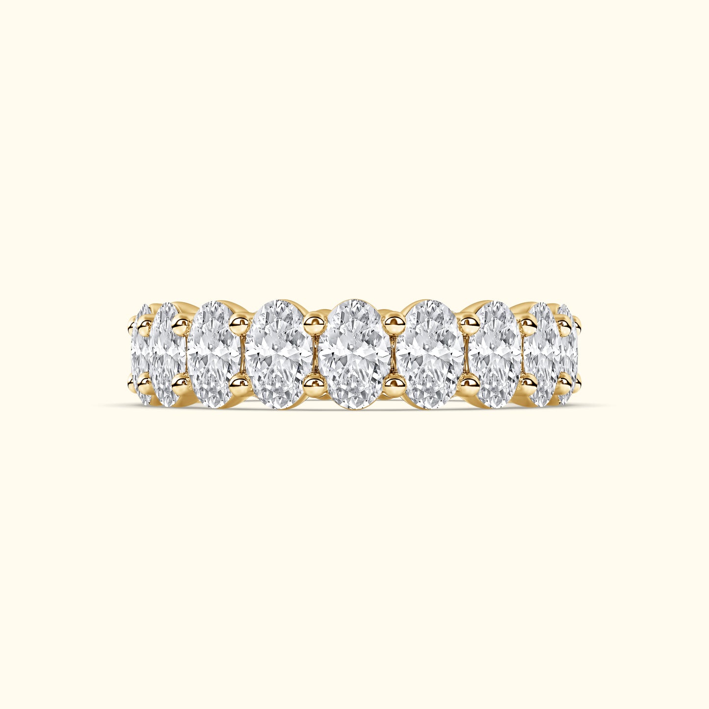 Gold band ring with multiple oval-shaped diamonds set in a delicate arrangement.