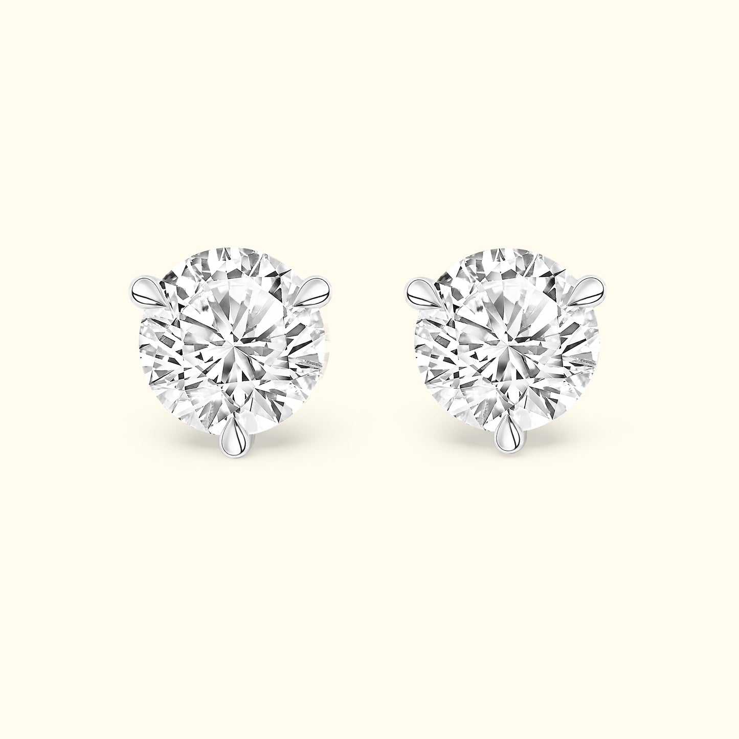 Round diamond stud earrings set in a simple silver setting.