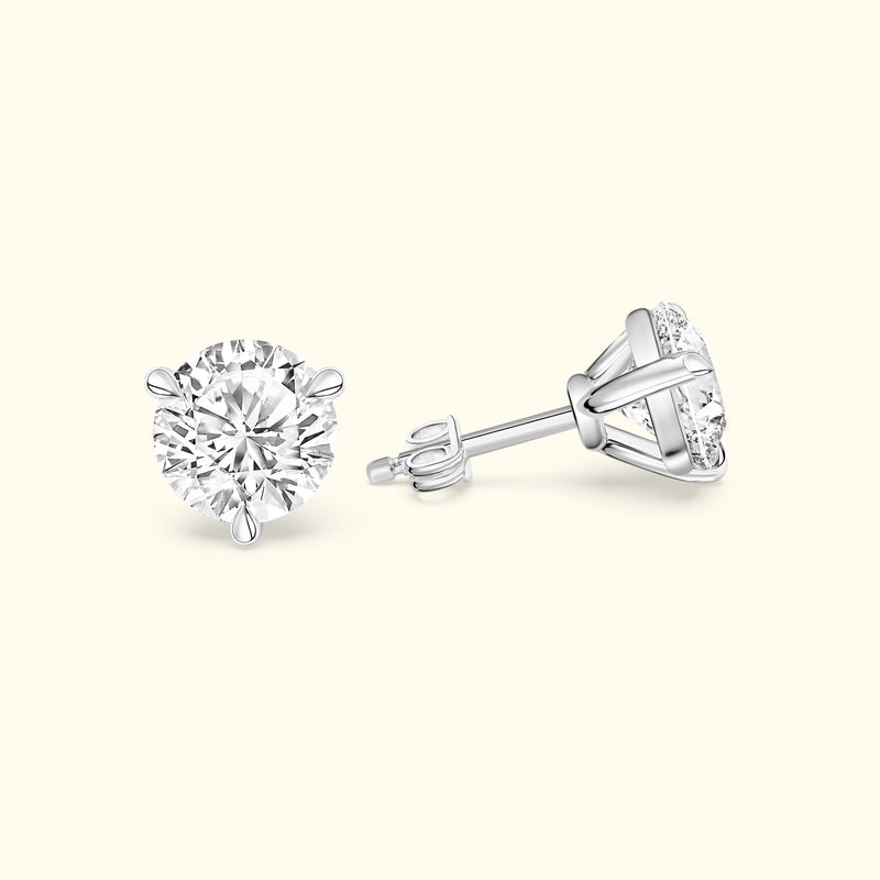 Round diamond stud earrings in a sleek silver setting, showcasing brilliance and elegance.