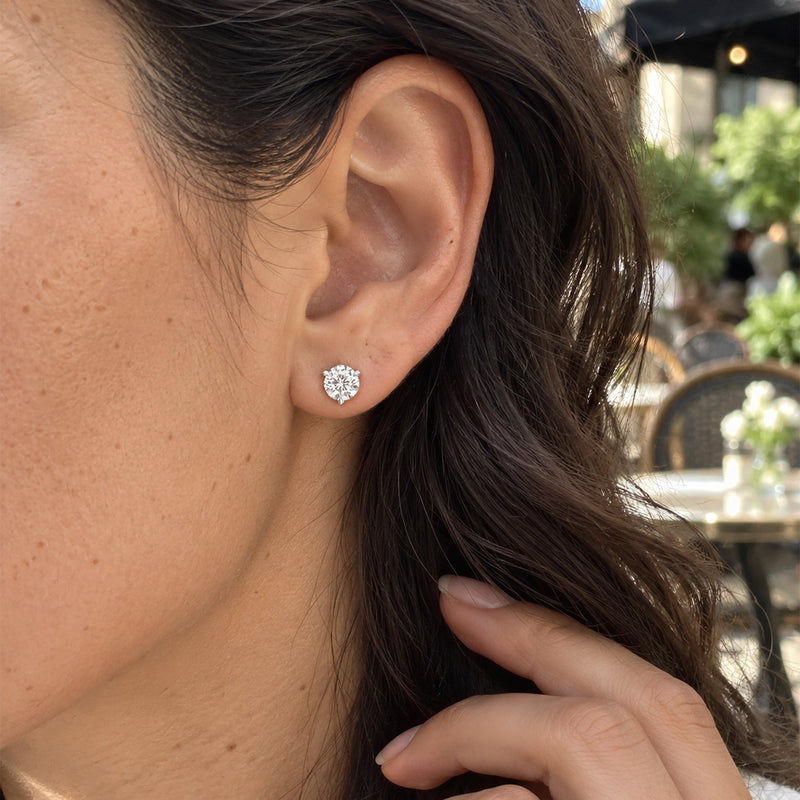 1.00 CTW round lab-grown diamond stud earrings in a signature three-prong martini-style 14kt white gold setting.