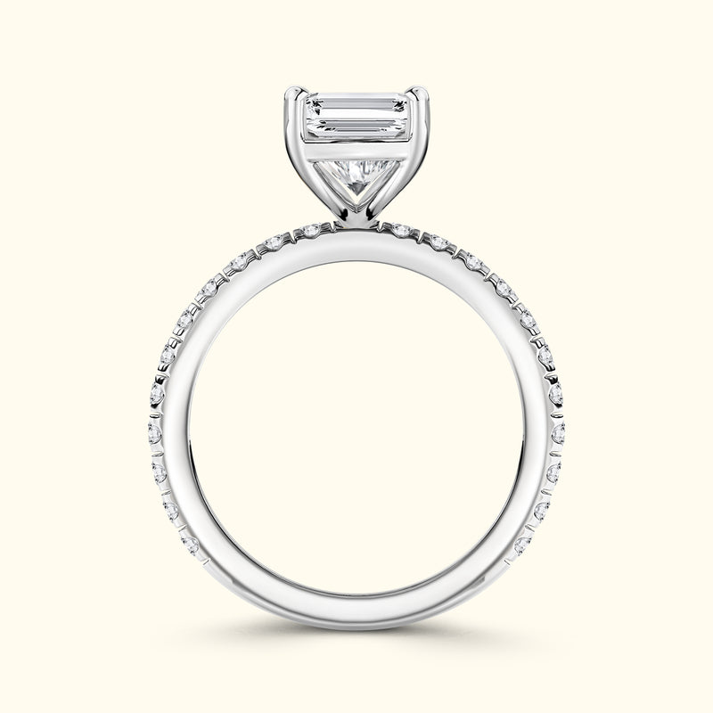Elegant silver engagement ring featuring a central diamond surrounded by smaller stones.