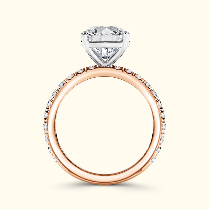 Heart-shaped diamond engagement ring with a rose gold band and small accent stones.