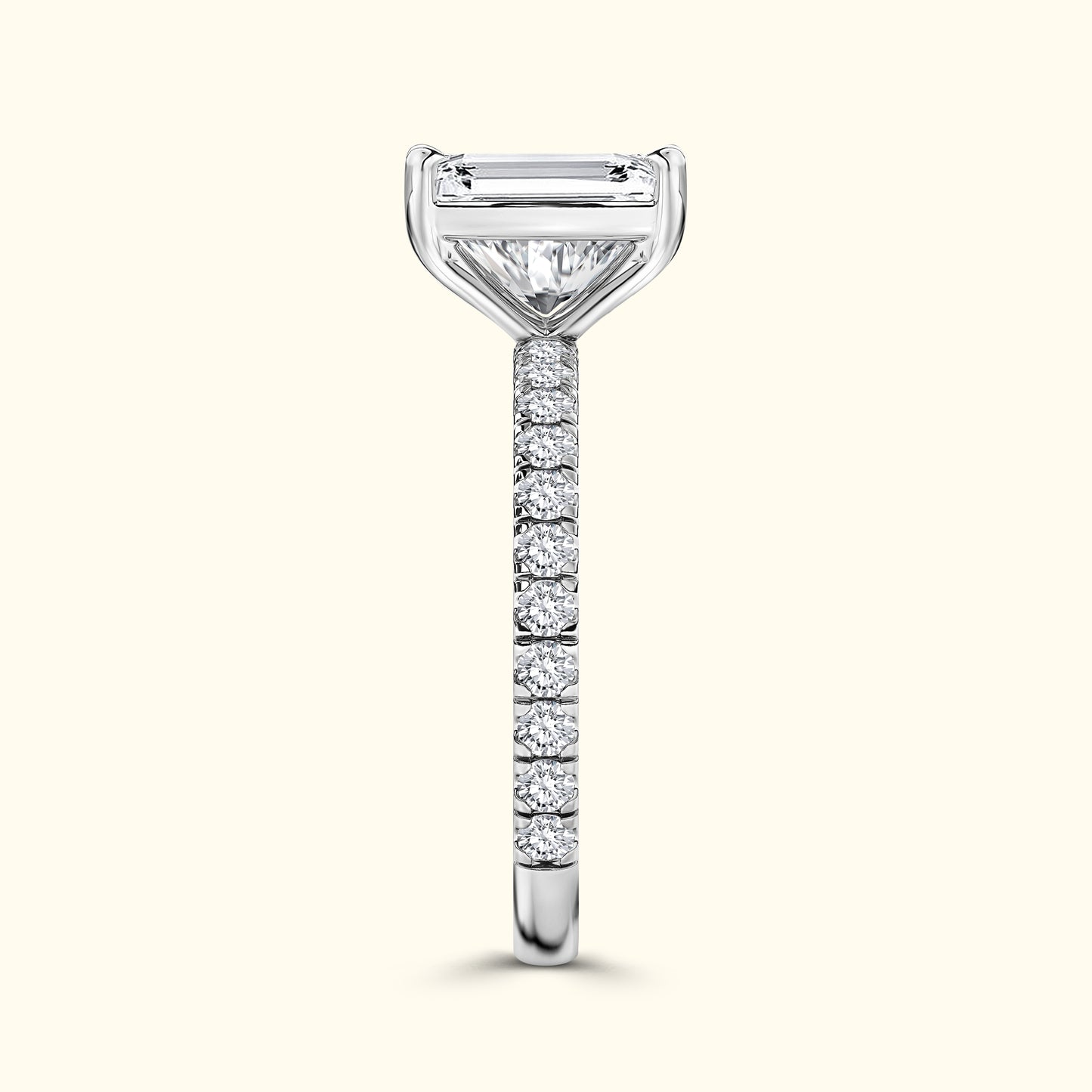 Elegant diamond ring with a central emerald-cut stone and a pave-set band.