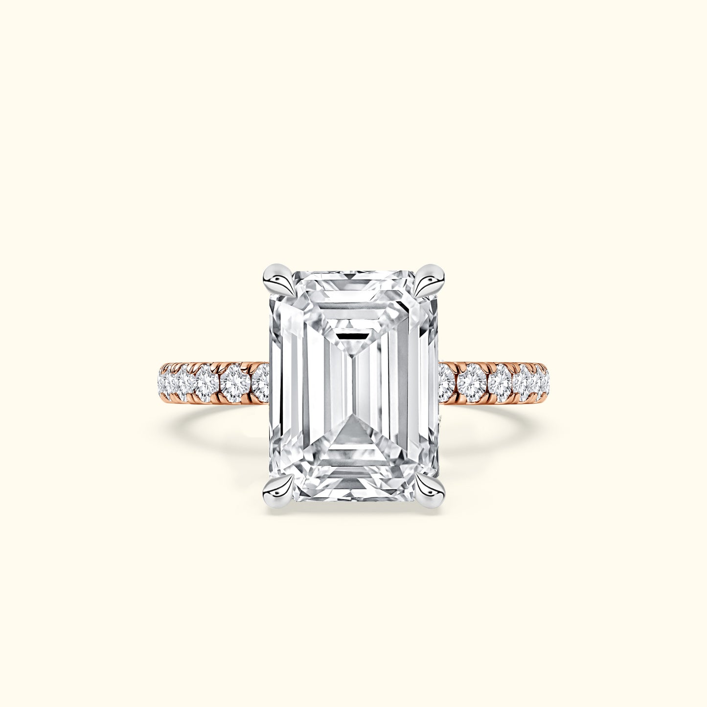 Emerald-cut diamond ring with a rose gold band and smaller diamonds along the shank.