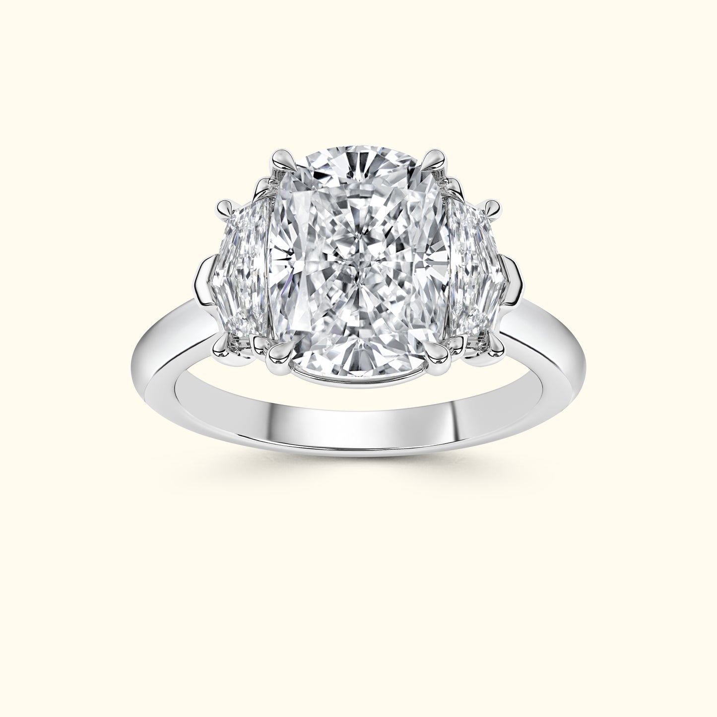 A three-stone diamond ring featuring a large center diamond flanked by two smaller diamonds.