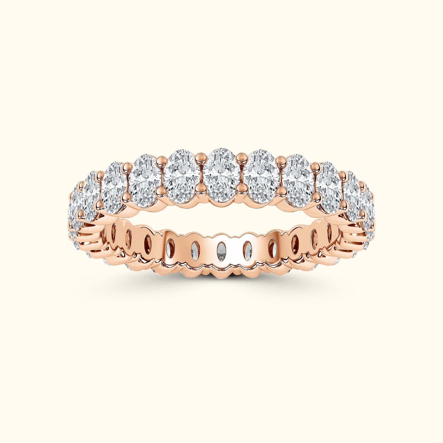 Rose gold ring featuring a row of oval diamonds set in a sparkling band.