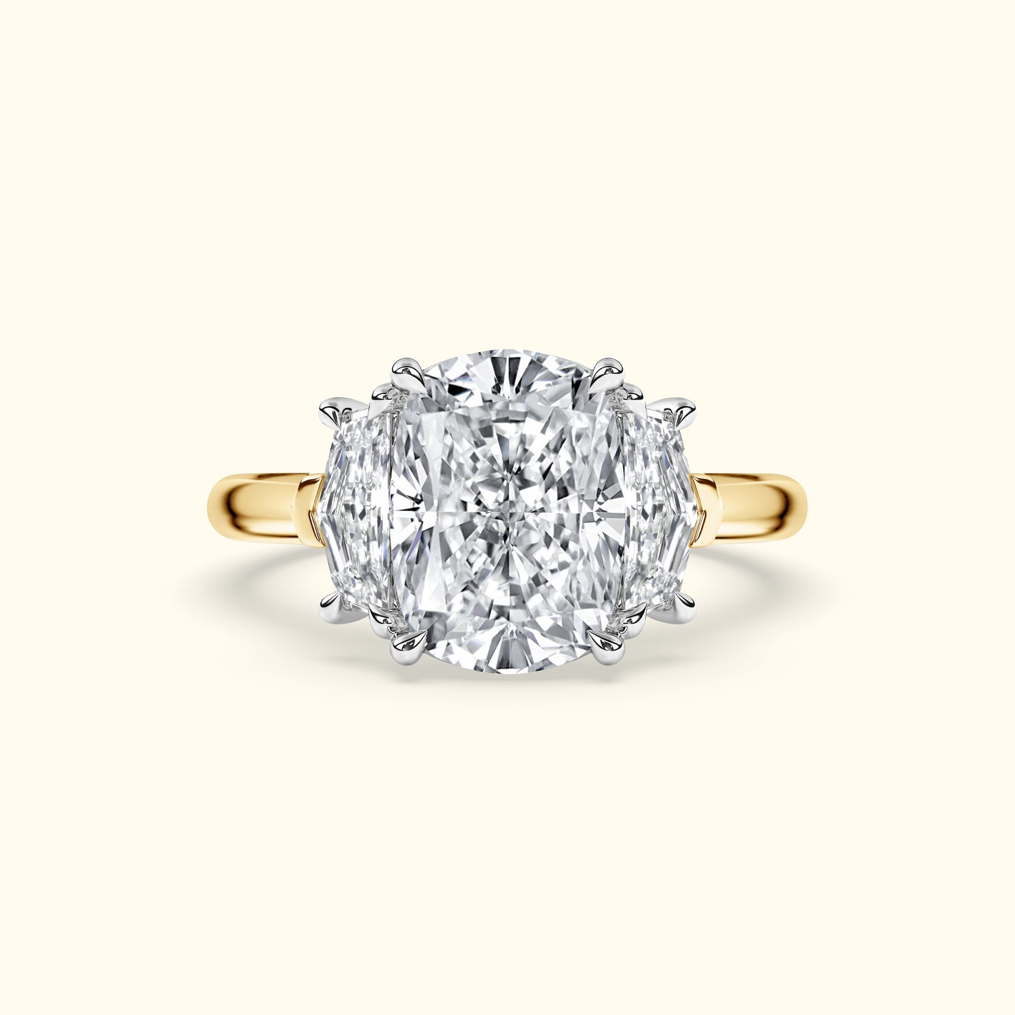 Three-stone diamond ring with a large center stone set in yellow gold.
