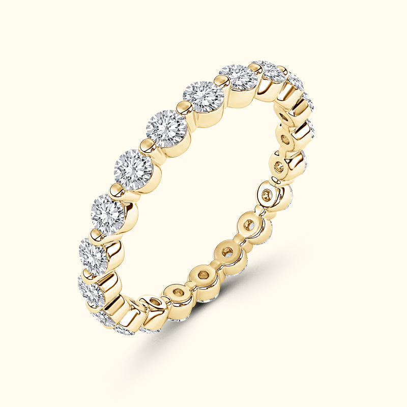 Yellow gold eternity band set with round diamonds.
