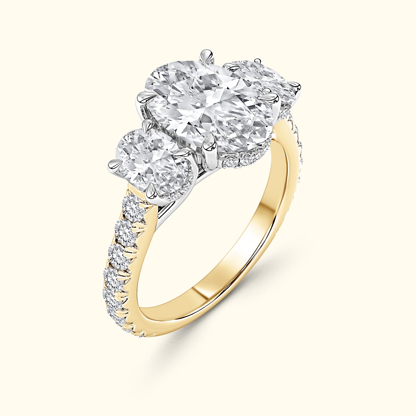 Three-stone diamond ring with a gold band and intricate pave setting.