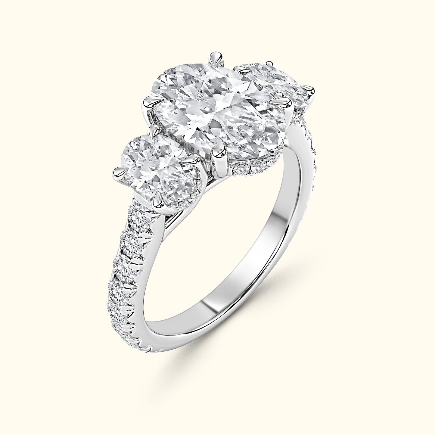 Three-stone diamond ring with a central large diamond and smaller side stones on a white gold band.