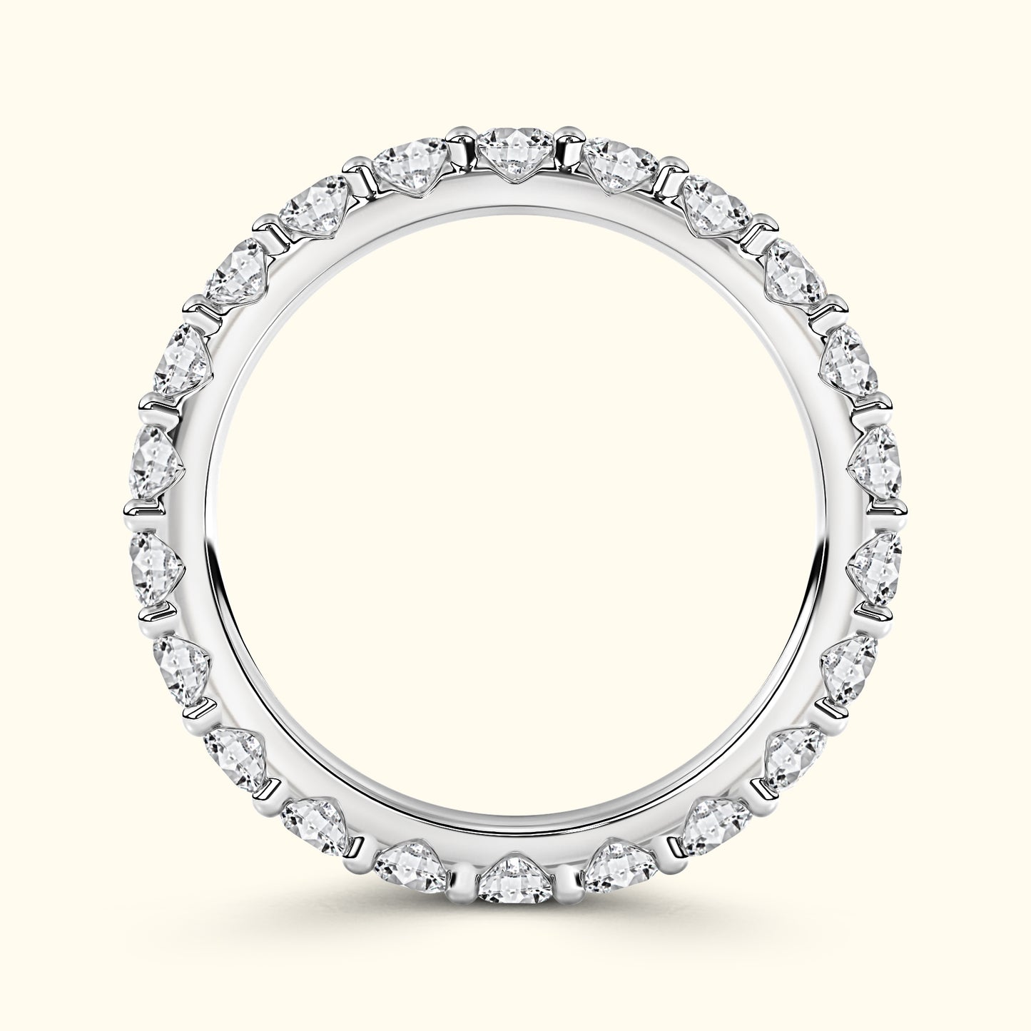 A sparkling diamond eternity ring with a shiny silver band.