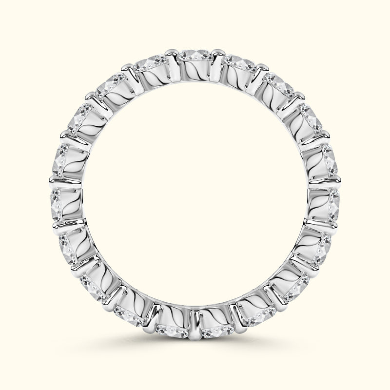 A circular silver ring adorned with multiple evenly spaced diamonds.