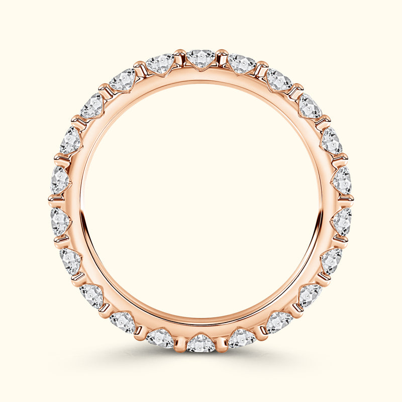 Rose gold ring adorned with sparkling pear-shaped diamonds around the band.