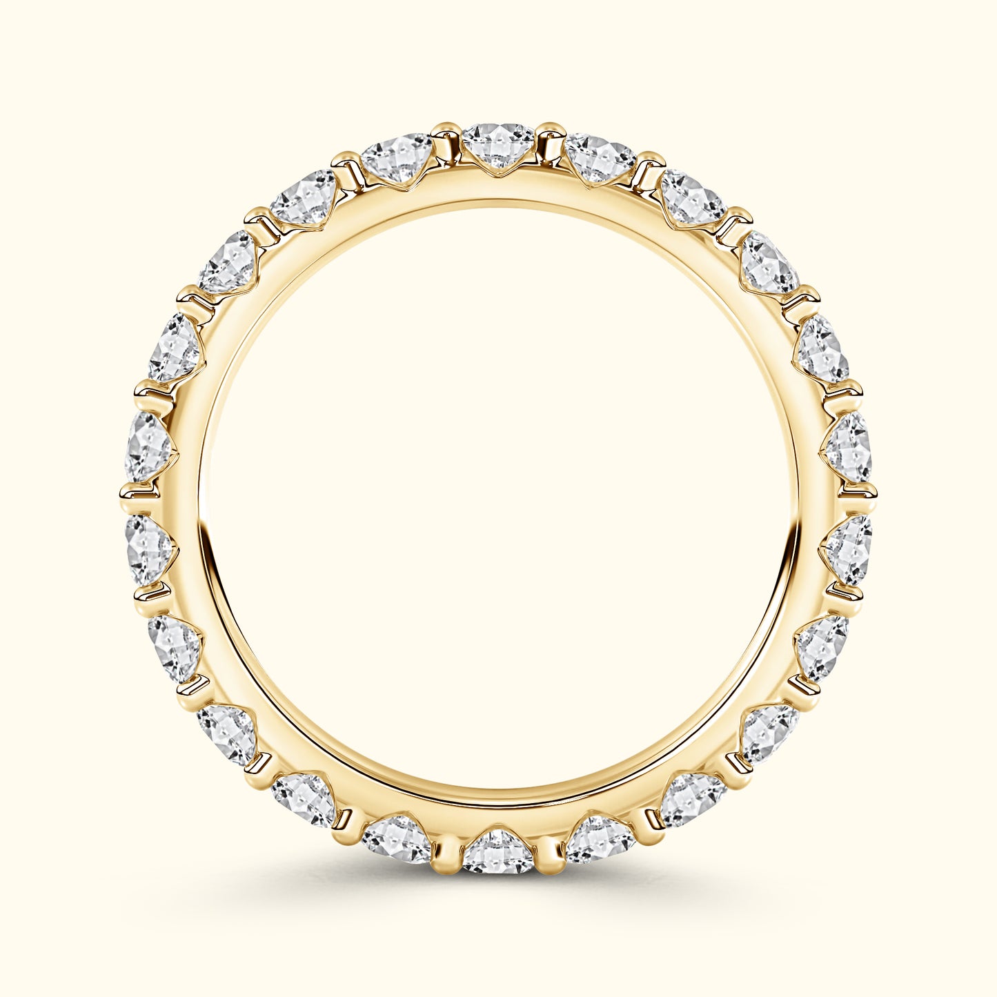Gold ring with pear-shaped diamonds around the band against a light background.