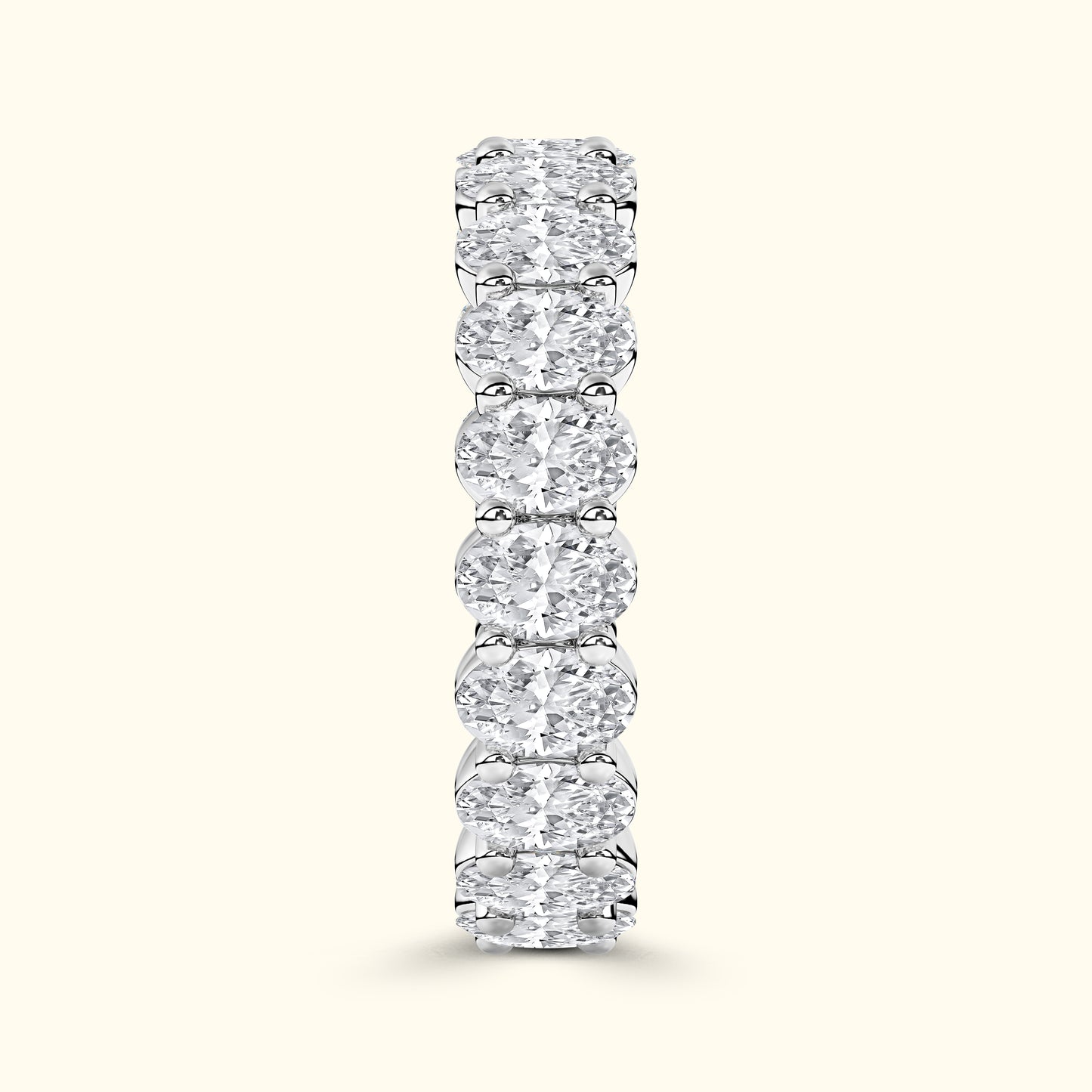 Elegant diamond band with alternating round and oval diamonds set in a smooth prong setting.