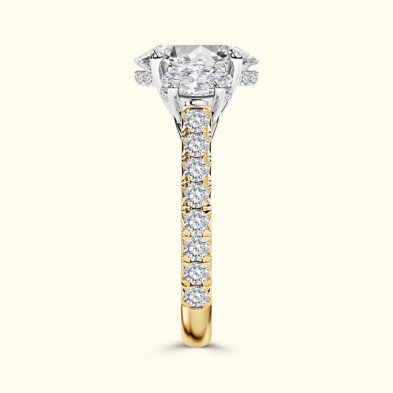 Elegant two-tone engagement ring featuring a large diamond and smaller side stones.