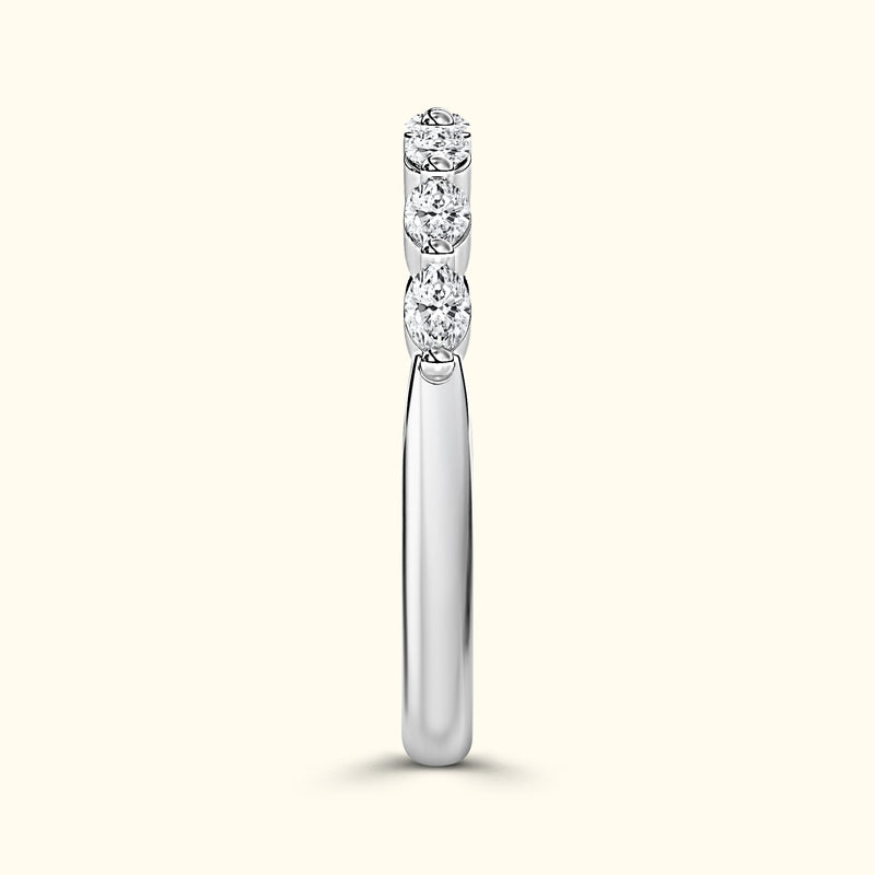 Slim silver ring featuring four sparkling round diamonds arranged vertically.