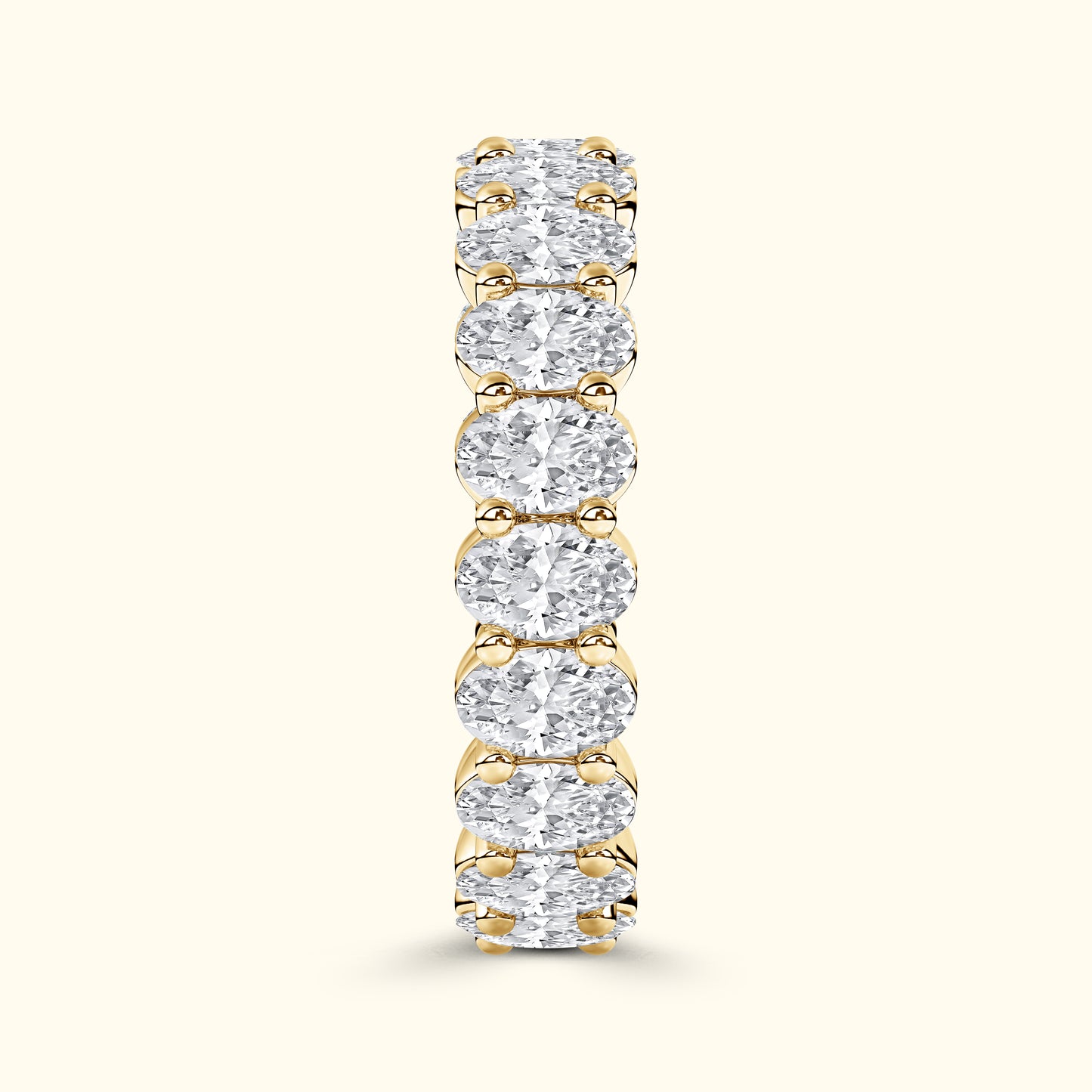 Gold band ring adorned with evenly spaced, sparkling round diamonds.
