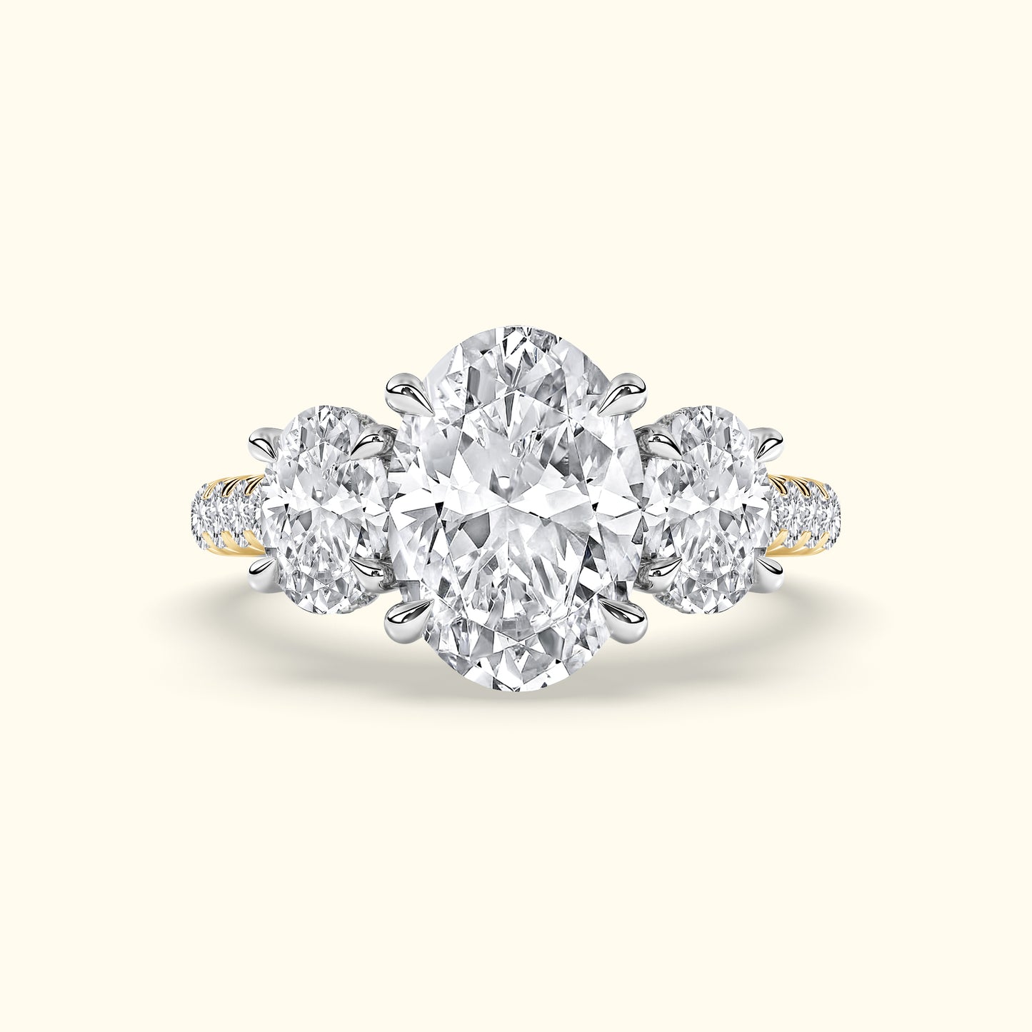 Three-stone diamond ring featuring a central oval diamond and two round diamonds on the side.