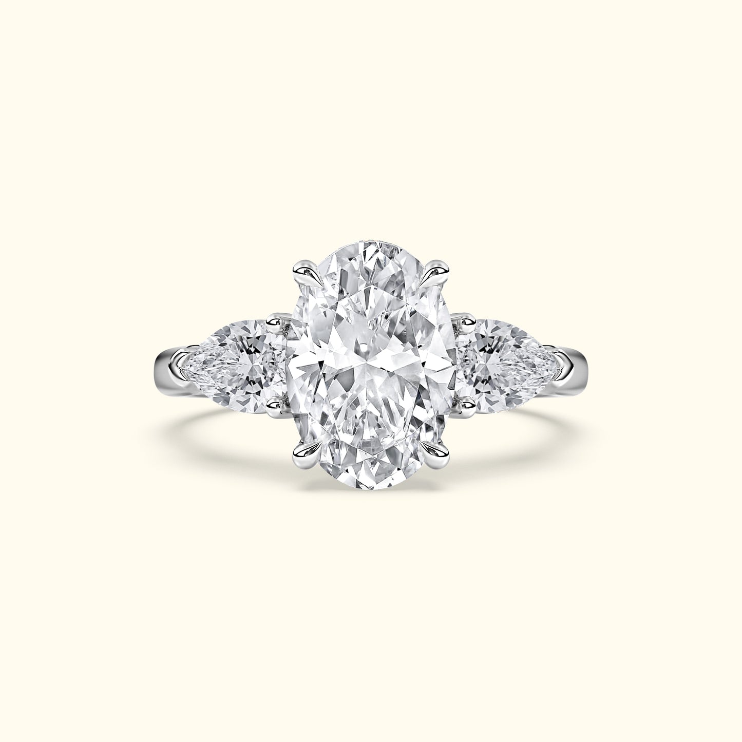 Oval diamond engagement ring with sidestones, set in a polished white gold band.