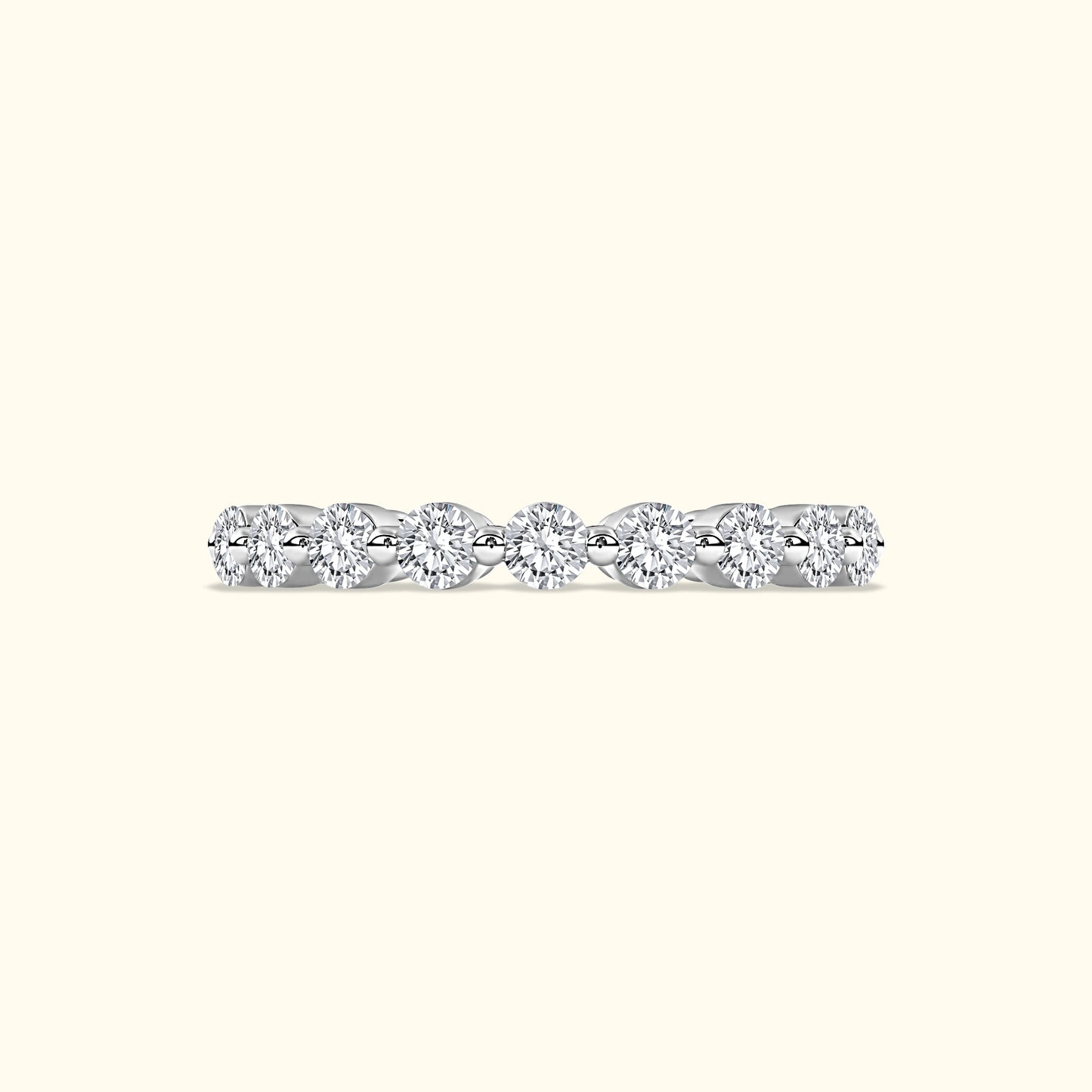 A delicate diamond band featuring several round, sparkling diamonds set in a sleek metal setting.