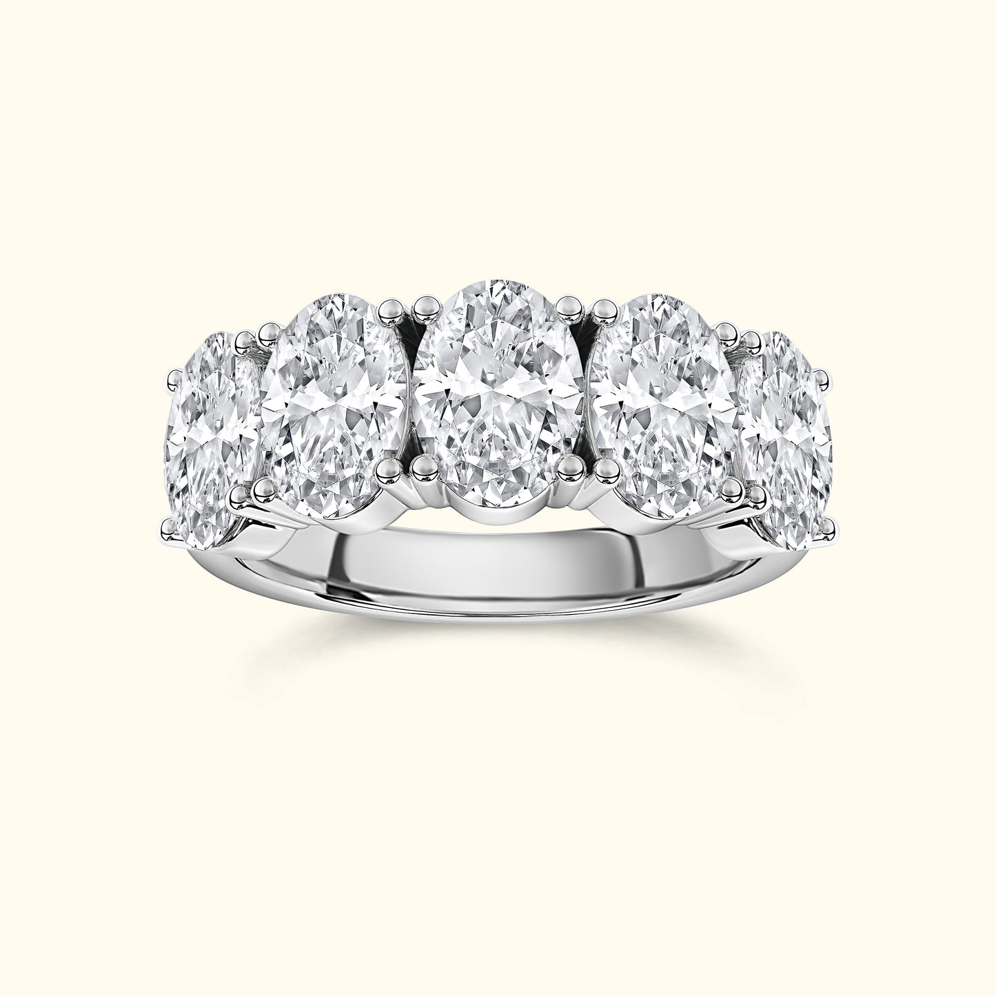 Silver ring featuring five oval diamonds arranged in a row.