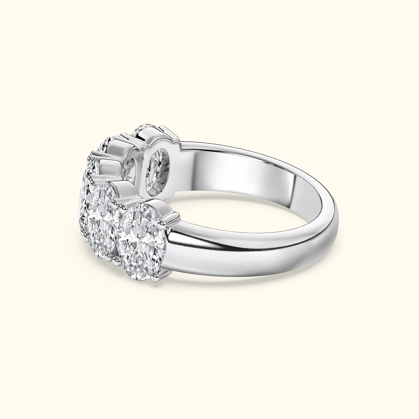 Three sparkling diamonds set in a sleek, polished silver band.