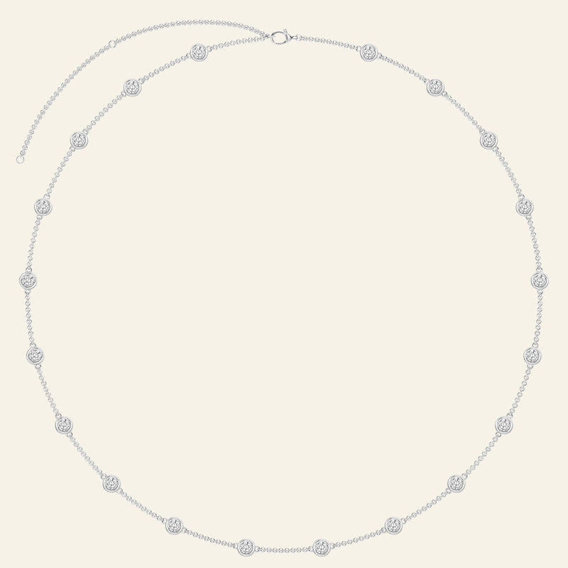 Silver necklace featuring evenly spaced circular diamond accents.