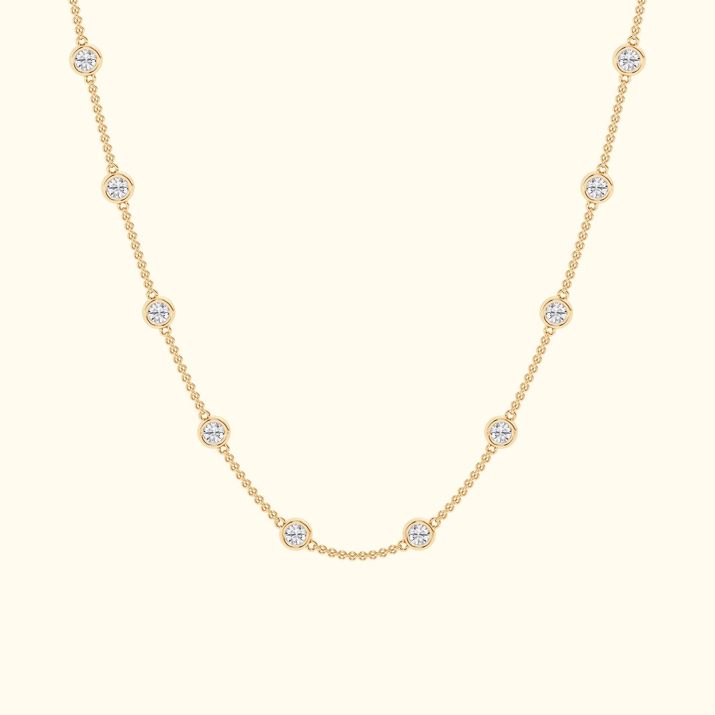Delicate gold necklace featuring evenly spaced circular diamond accents.