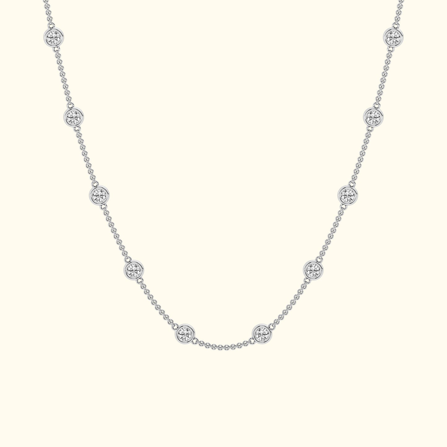 Delicate silver necklace with circular diamond accents evenly spaced along the chain.