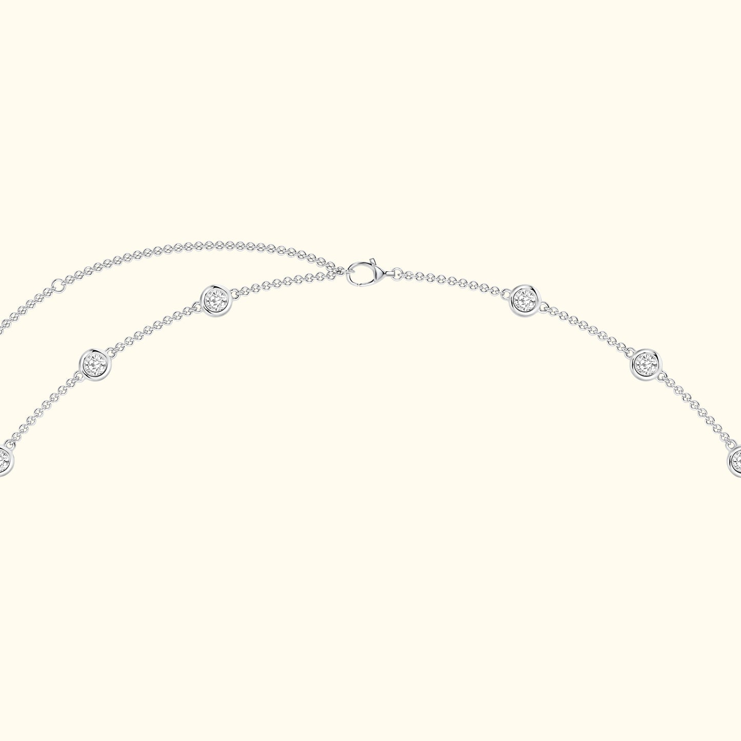 Silver necklace with circular decorative elements evenly spaced along the chain.