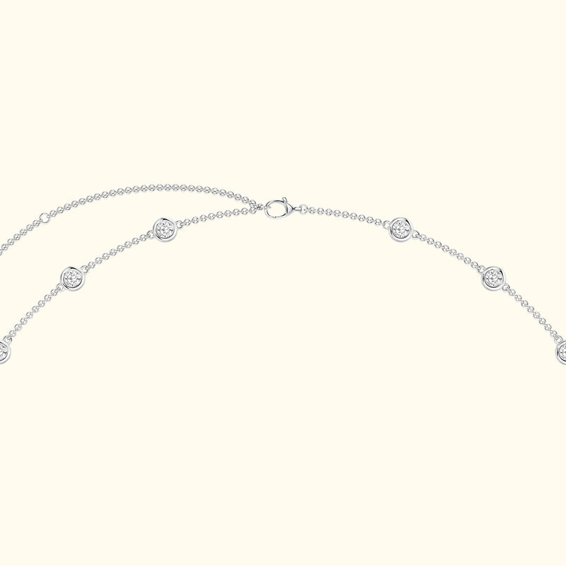 Silver necklace with circular decorative elements evenly spaced along the chain.