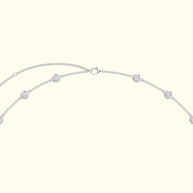 Delicate silver necklace with circular pendant details and a simple clasp.