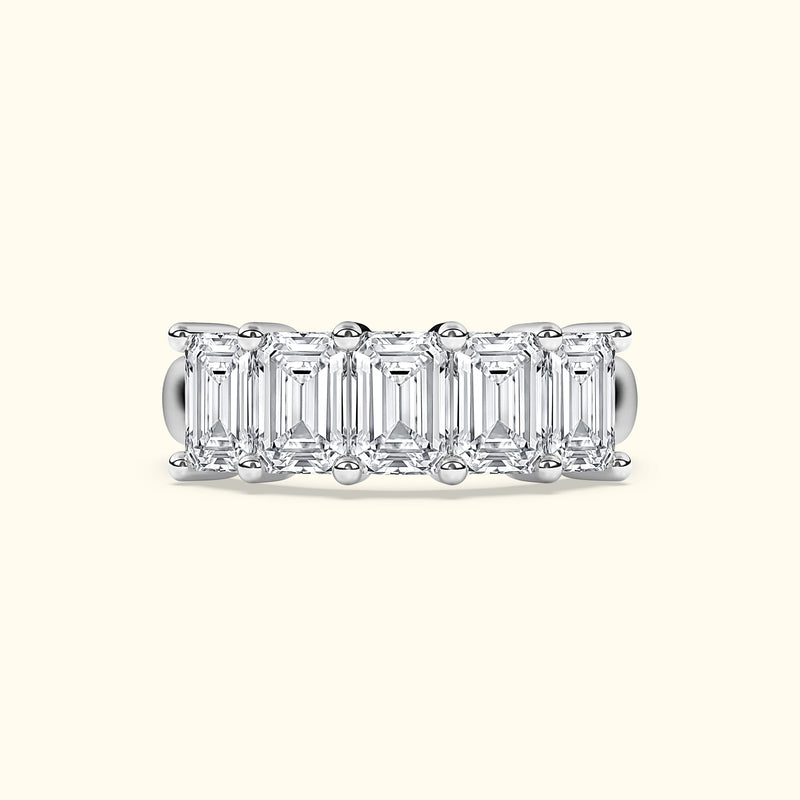 Five emerald-cut diamonds set in a sleek silver band.