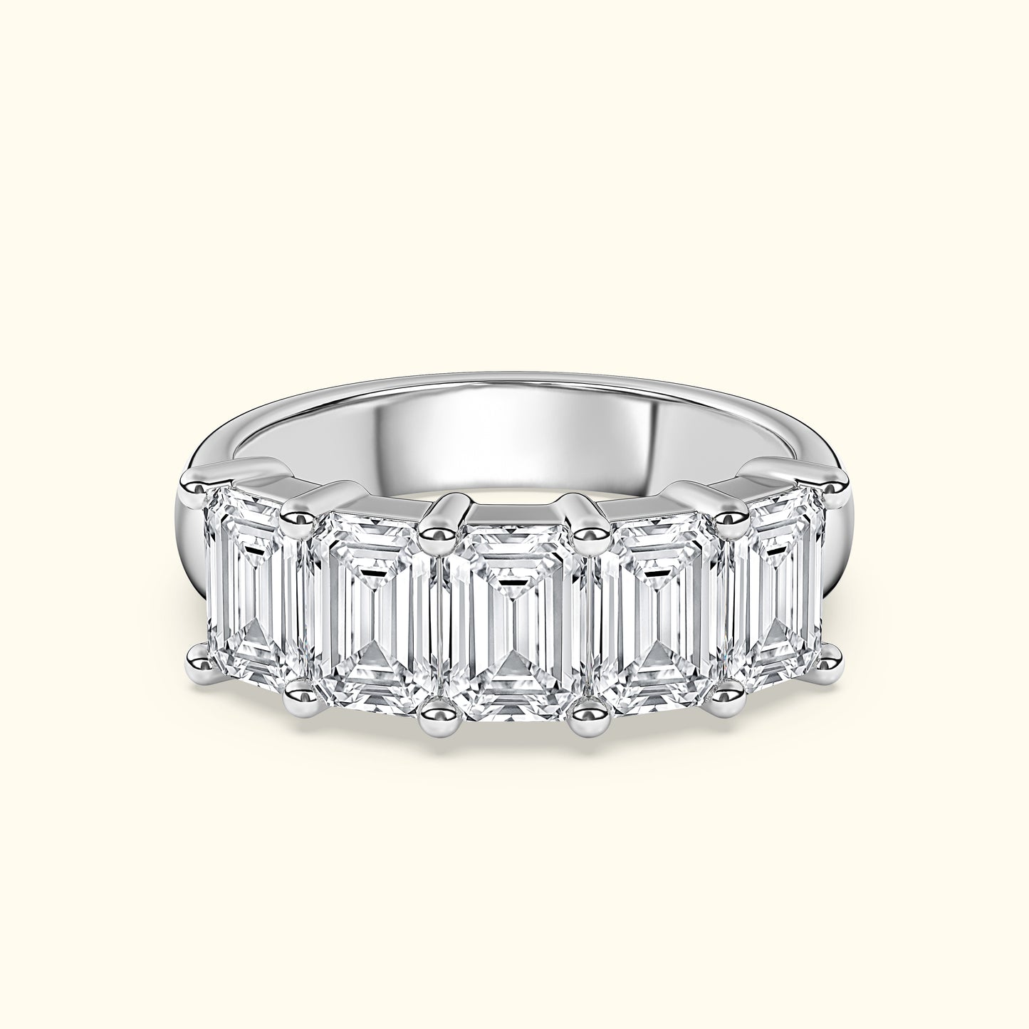 Elegant silver band ring set with five emerald-cut diamonds.