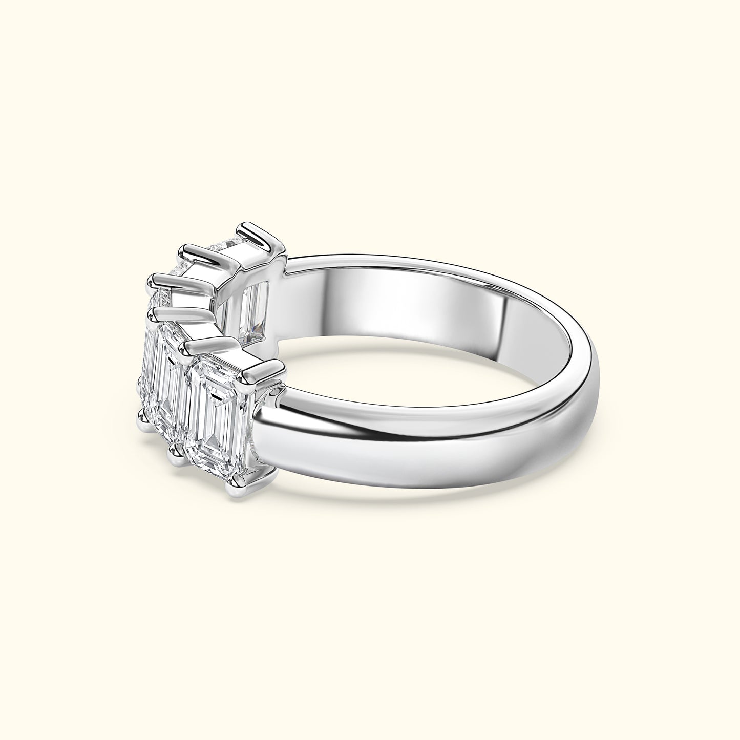 Elegant silver ring featuring three emerald-cut diamonds.