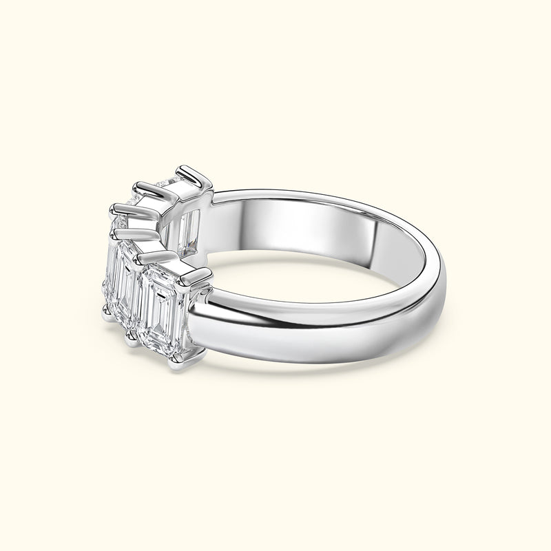 Elegant silver ring featuring three emerald-cut diamonds.