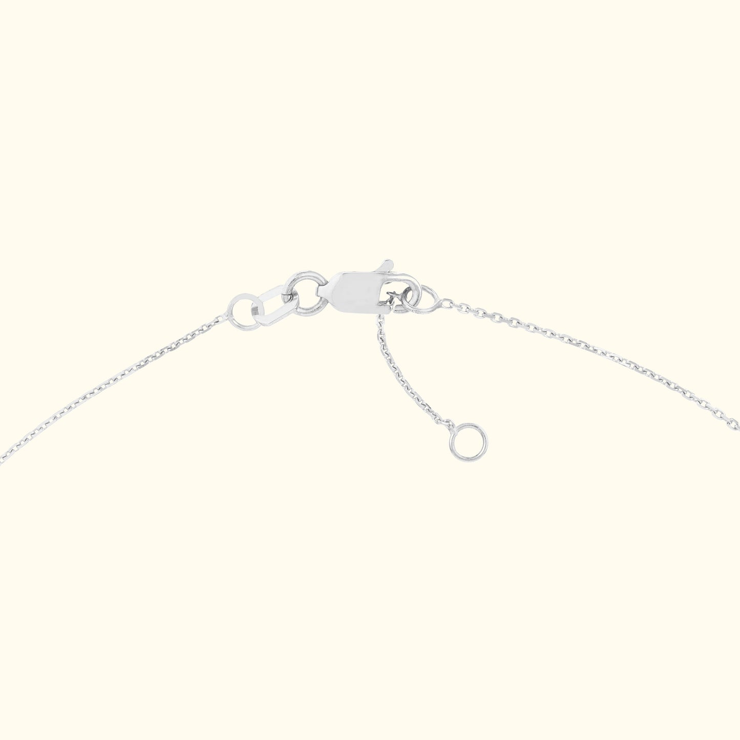 Close-up of a silver chain necklace clasp and extension chain.