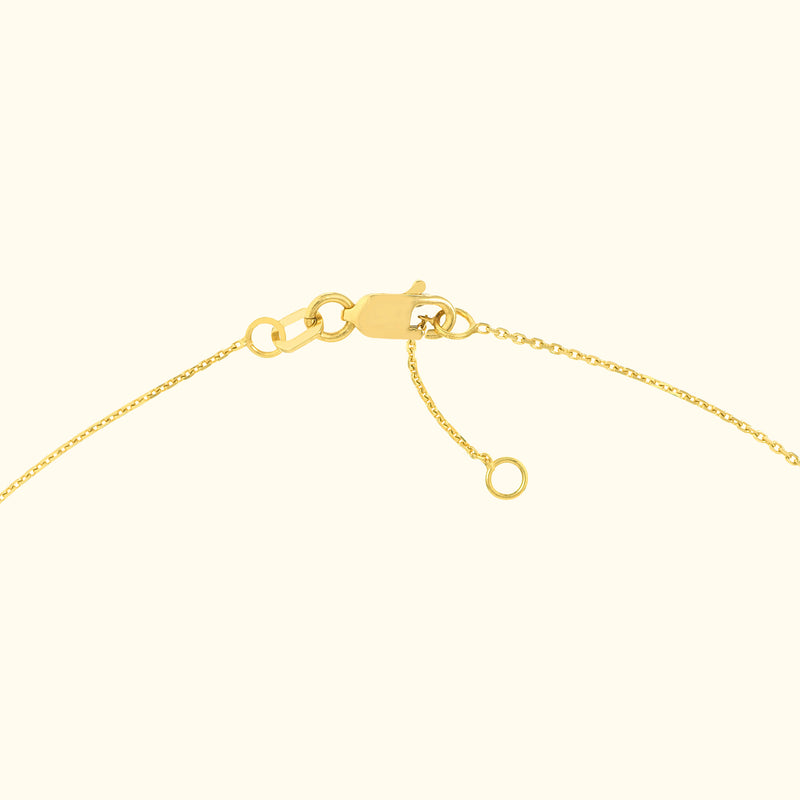 Close-up of a gold necklace clasp with a fine chain.