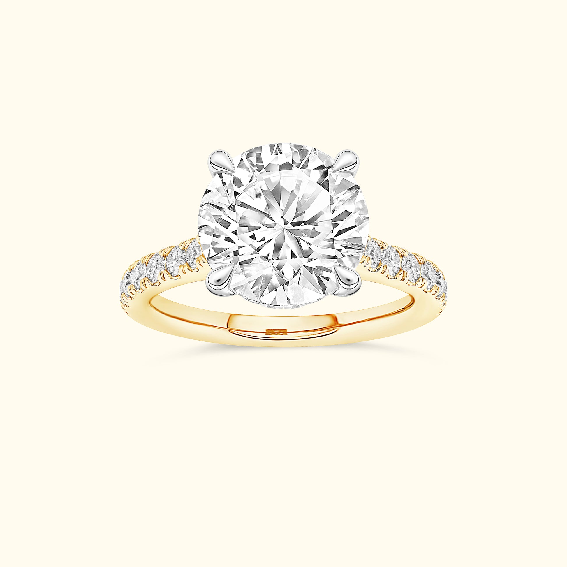 Round diamond engagement ring with a yellow gold band and sparkling side stones.