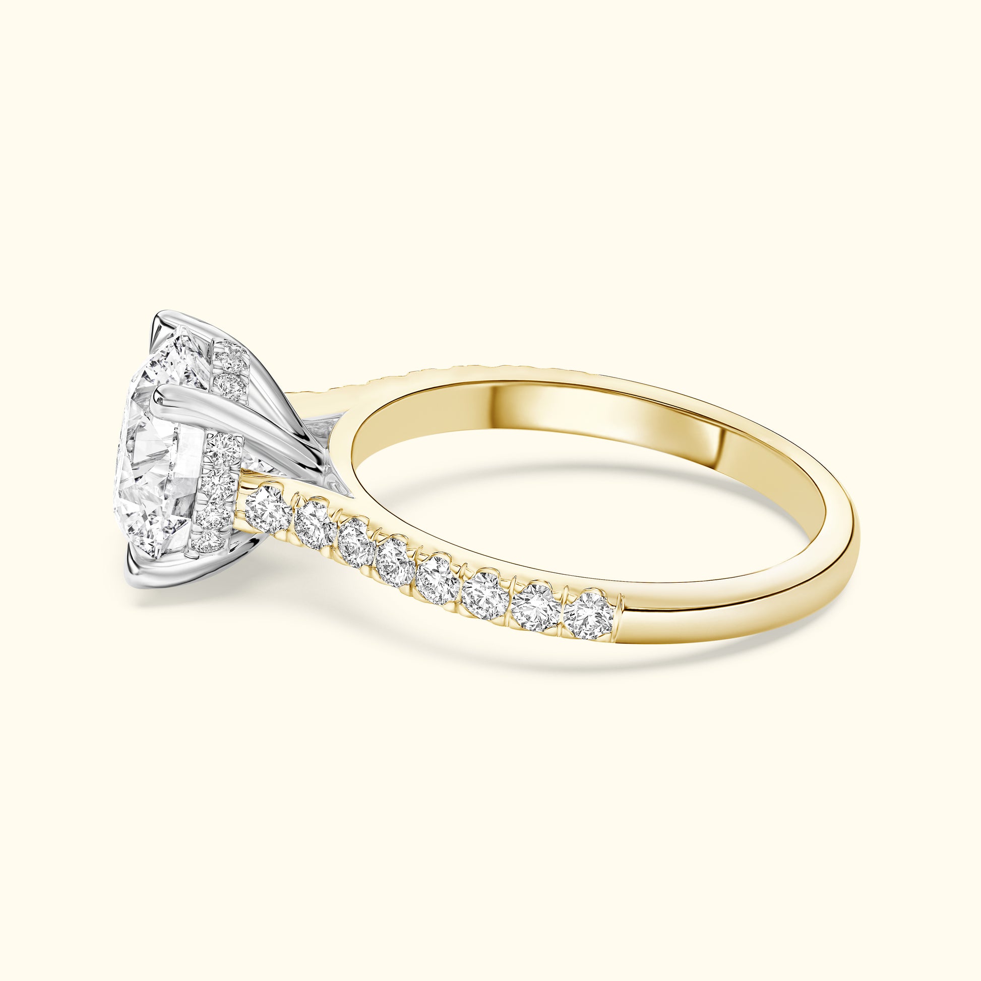 A two-toned engagement ring featuring a large round diamond centerpiece and smaller diamonds along the band.