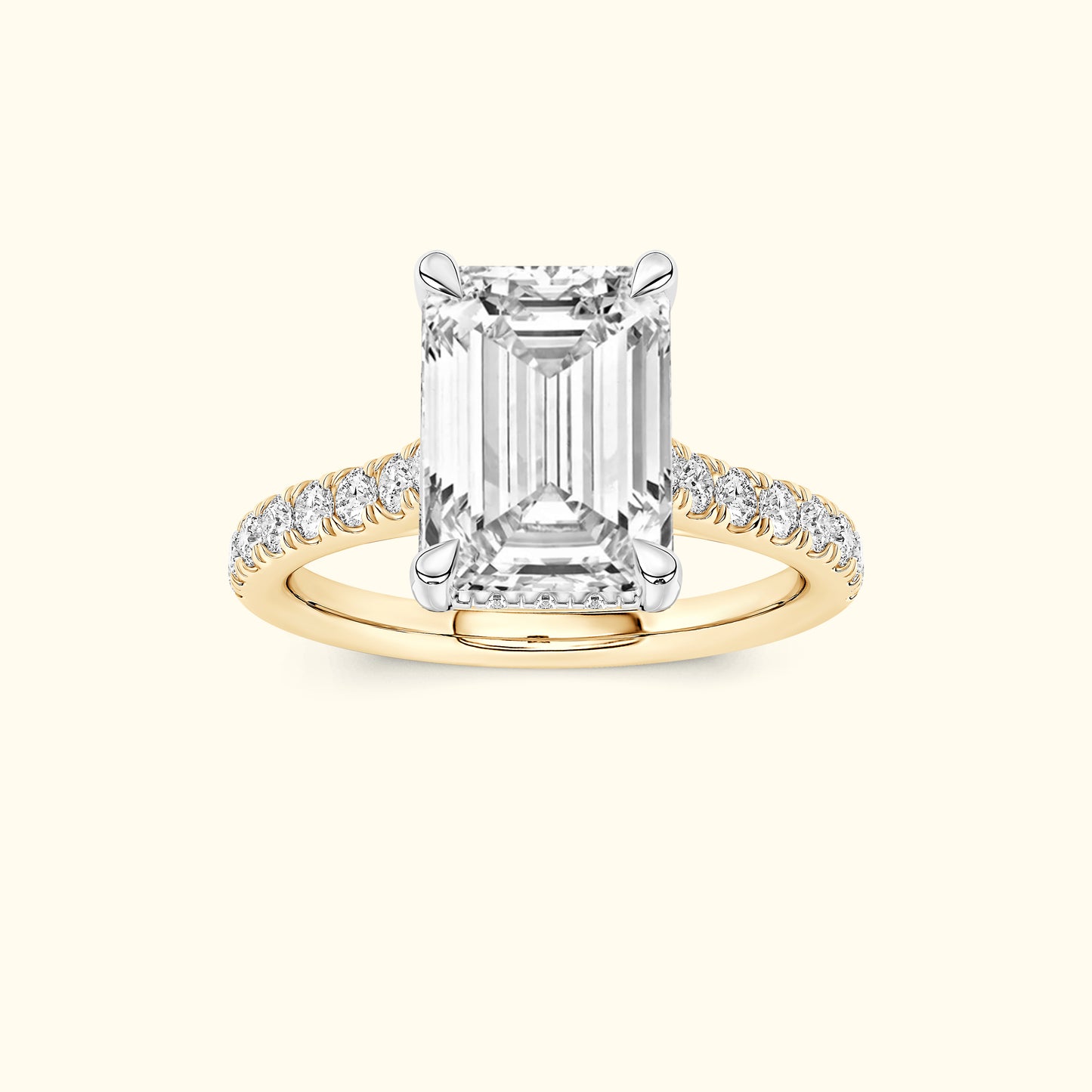 Emerald-cut diamond ring with a yellow gold band and small diamond accents.