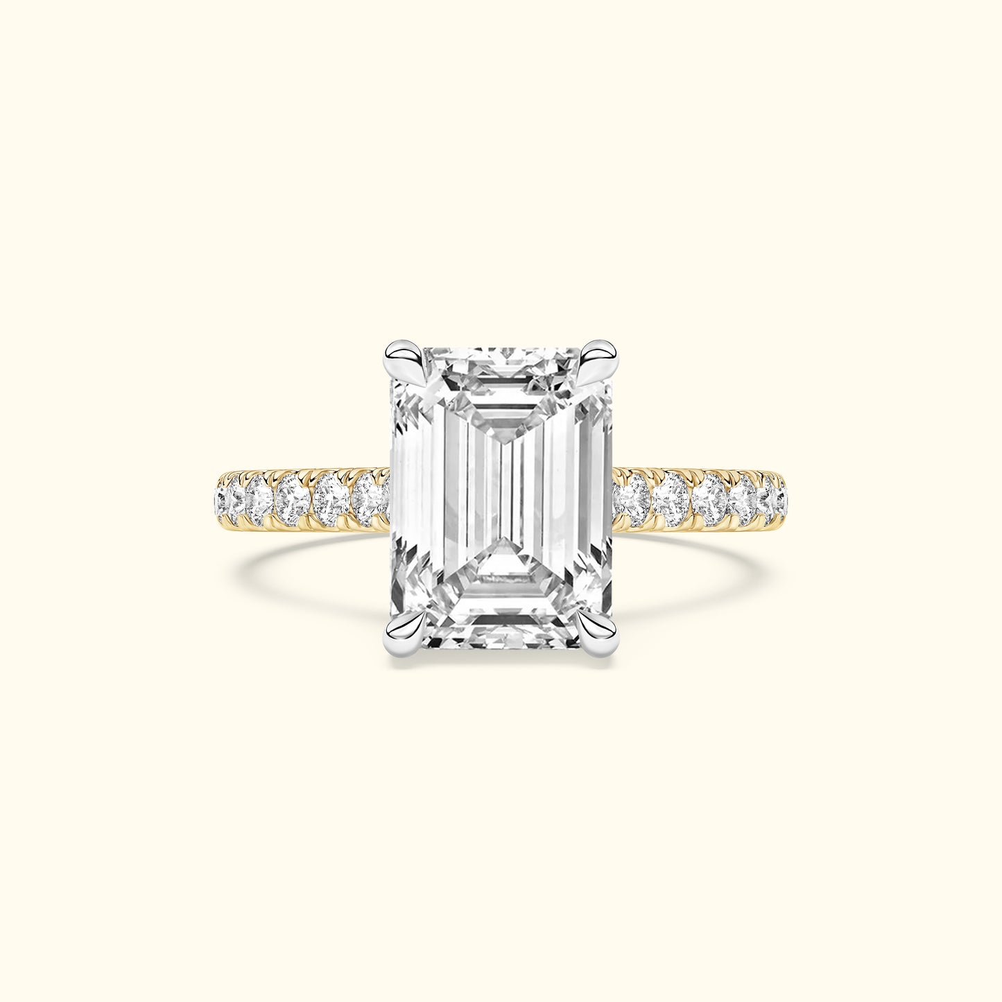 Emma-shaped diamond ring with a gold and silver band adorned with smaller diamonds.