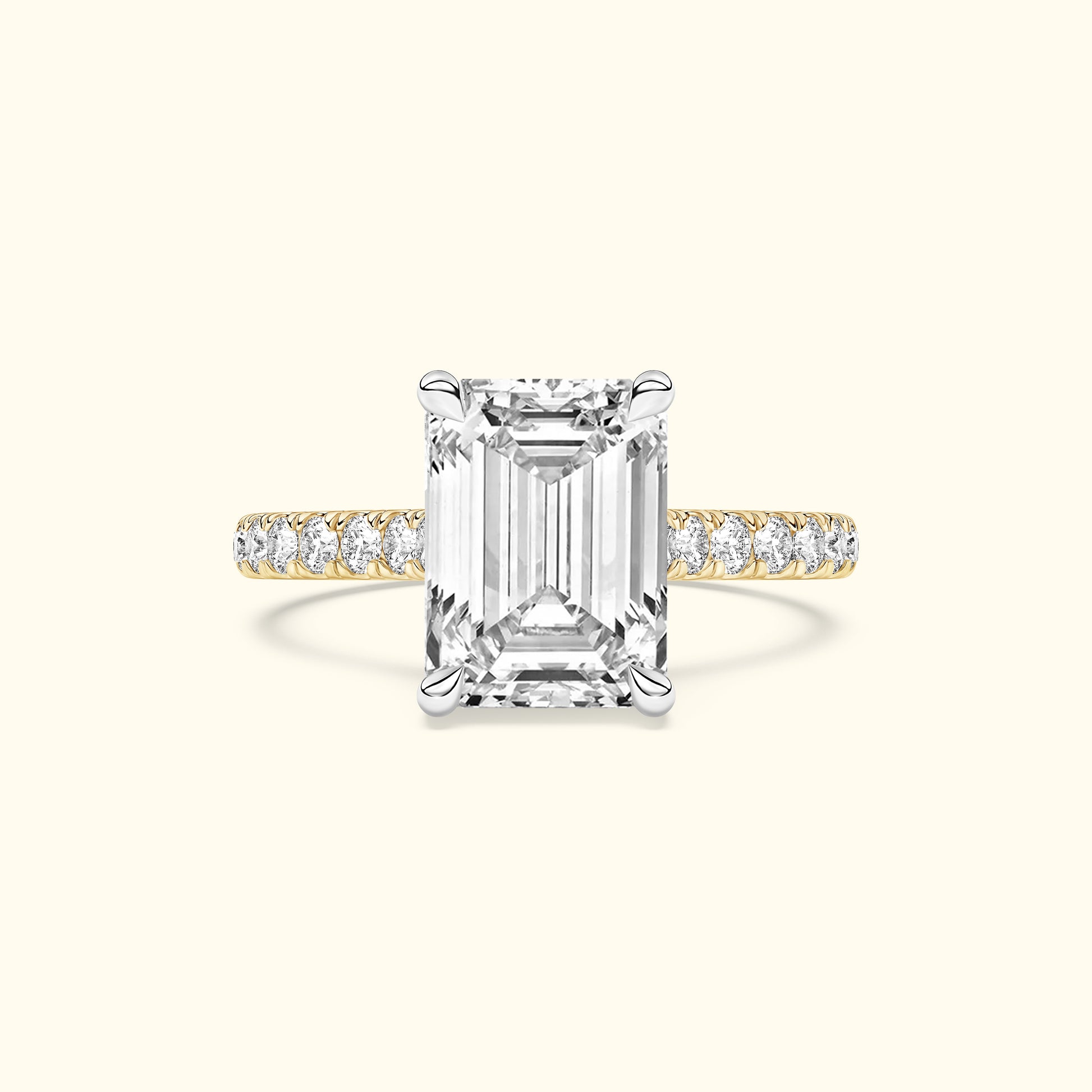 Emma-shaped diamond ring with a gold and silver band adorned with smaller diamonds.