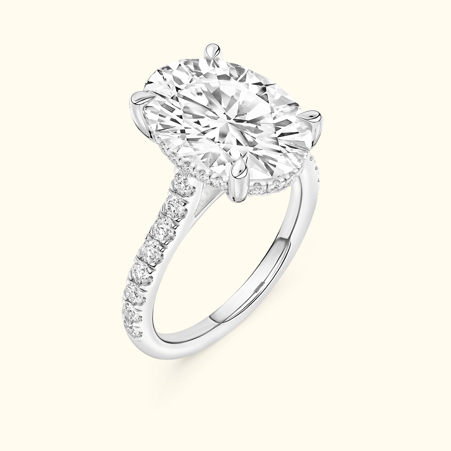 Brilliant oval-cut diamond engagement ring with a sparkling band of smaller diamonds.