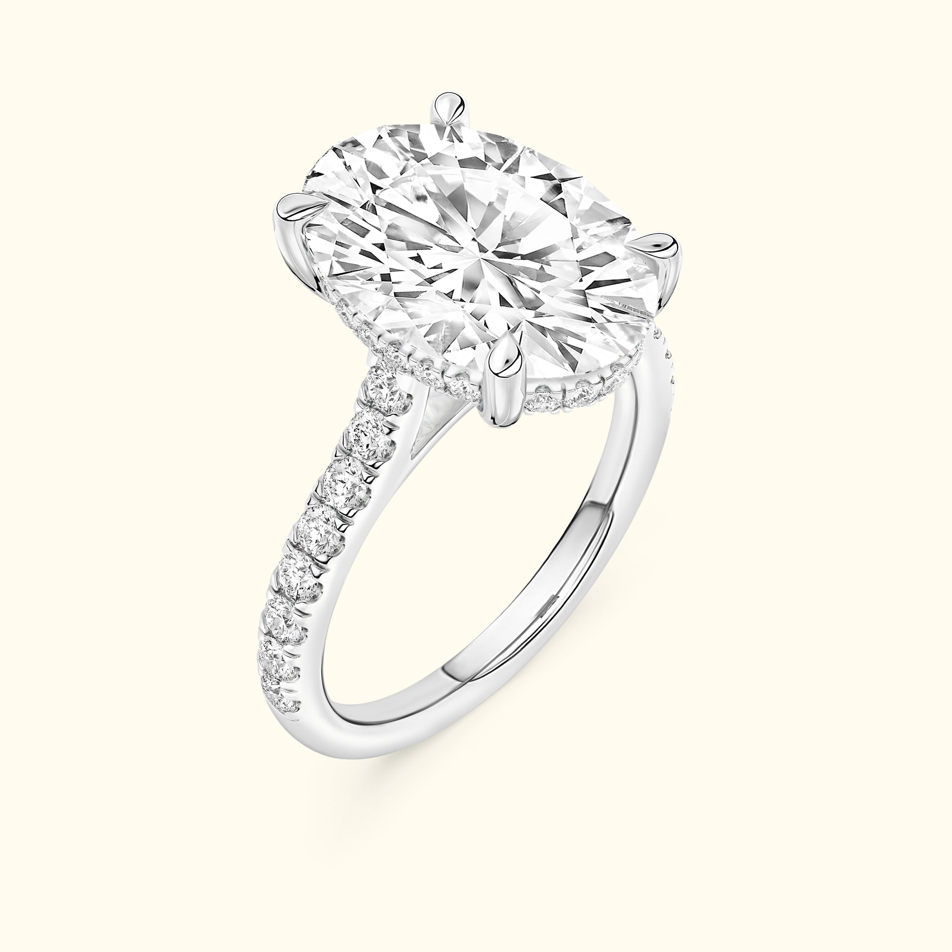 Brilliant oval-cut diamond engagement ring with a sparkling band of smaller diamonds.